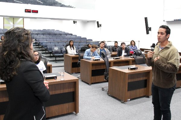 Imagem: Deputado estudante Claézio Aquiles agradece palestrante Cláudia Mietto em nome do Parlamento Jovem.