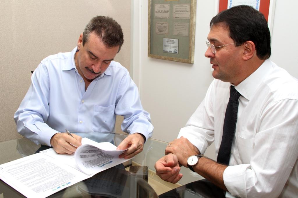 Imagem: O 1º secretário da Casa, deputado Paulo Corrêa, assinando o convênio na presença de Sérgio Longen, presidente da Fiems.