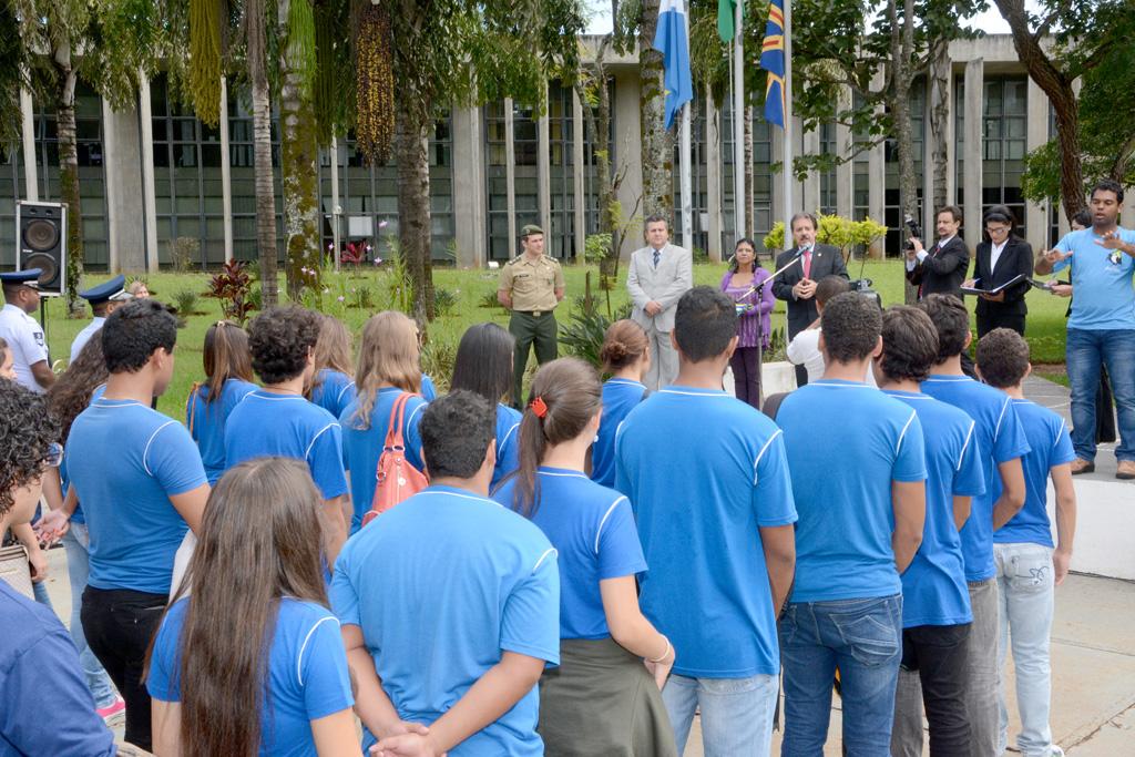 Imagem: Estudantes durante o hasteamento de bandeiras em frente à Assembleia.